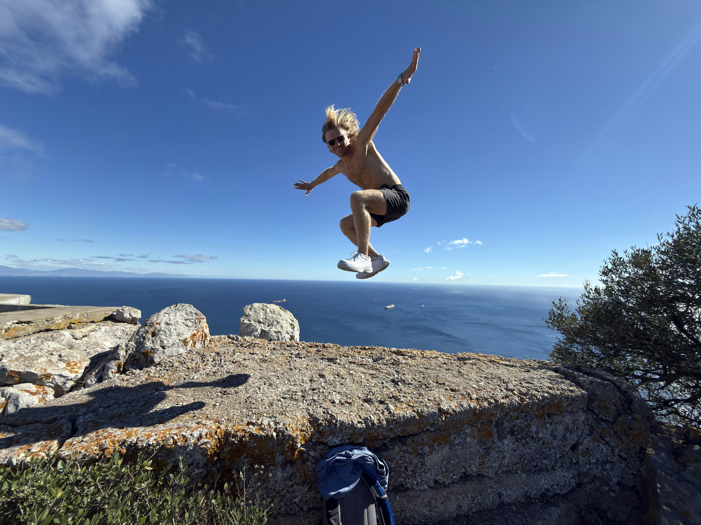 Logan Voss jumping in the air by the ocean